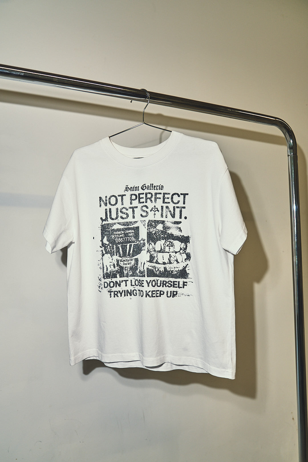 JUST SAINT T SHIRT — white tee on hanger, front graphic